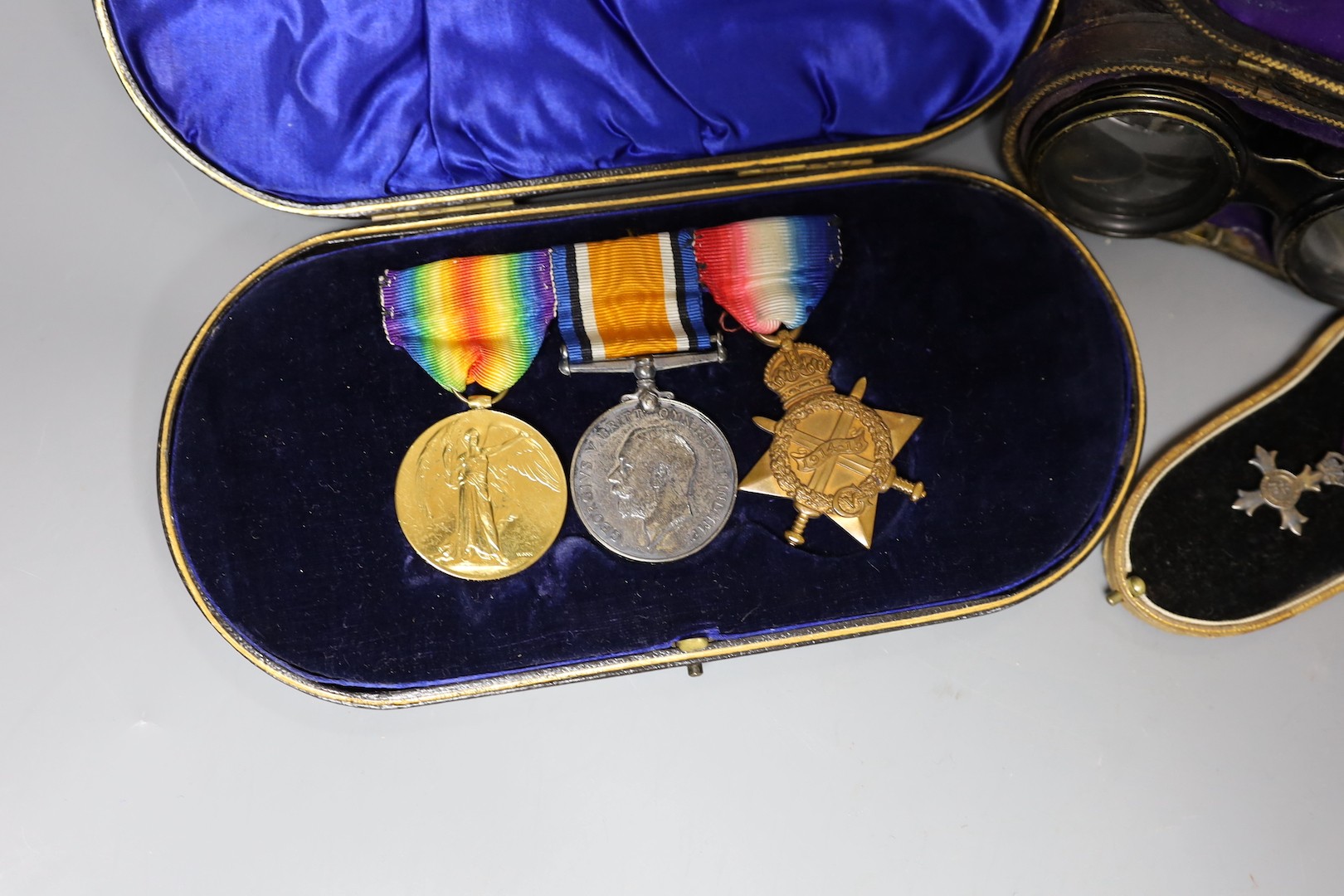 A WWI trio to J L Muir, Royal Fusiliers, a miniature medal, and a pair of opera glasses